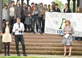 Supporters stand in solidarity with two activists resisting a grand jury summons