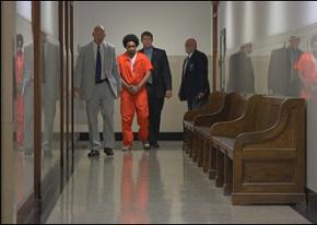 A victim of the drug war is marched through the court system