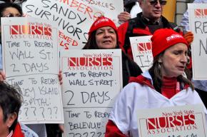 Protesters fill the steps of City Hall demanding more relief for the victims of Hurricane Sandy